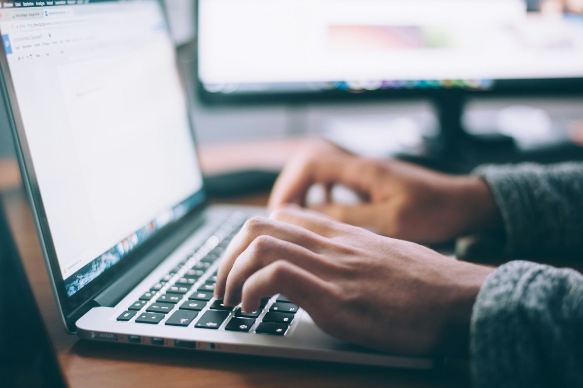 Solo founder at a laptop drafting clear pause-versus-cancel billing copy