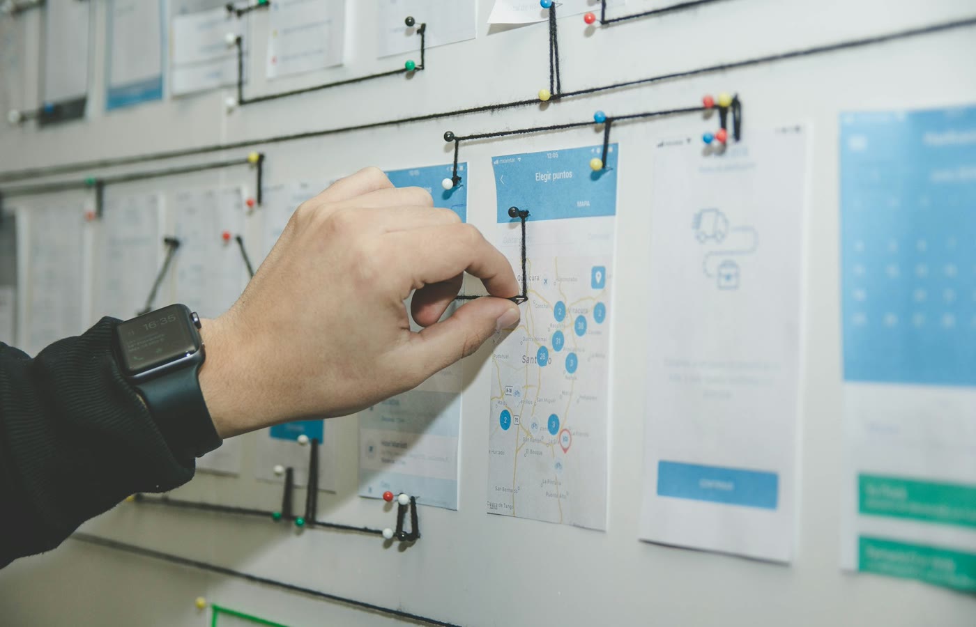 Product team reviewing a kanban-style roadmap board with sticky notes